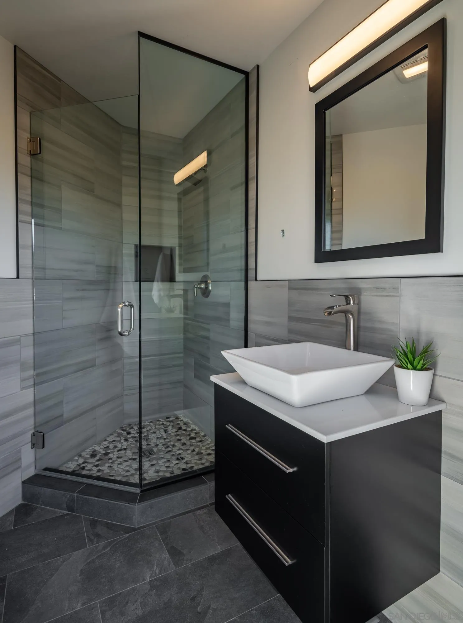 13384 Fallen Leaf Road Poway, CA 92064 - Photo 23 of 27 a bathroom with a granite countertop sink a mirror and shower