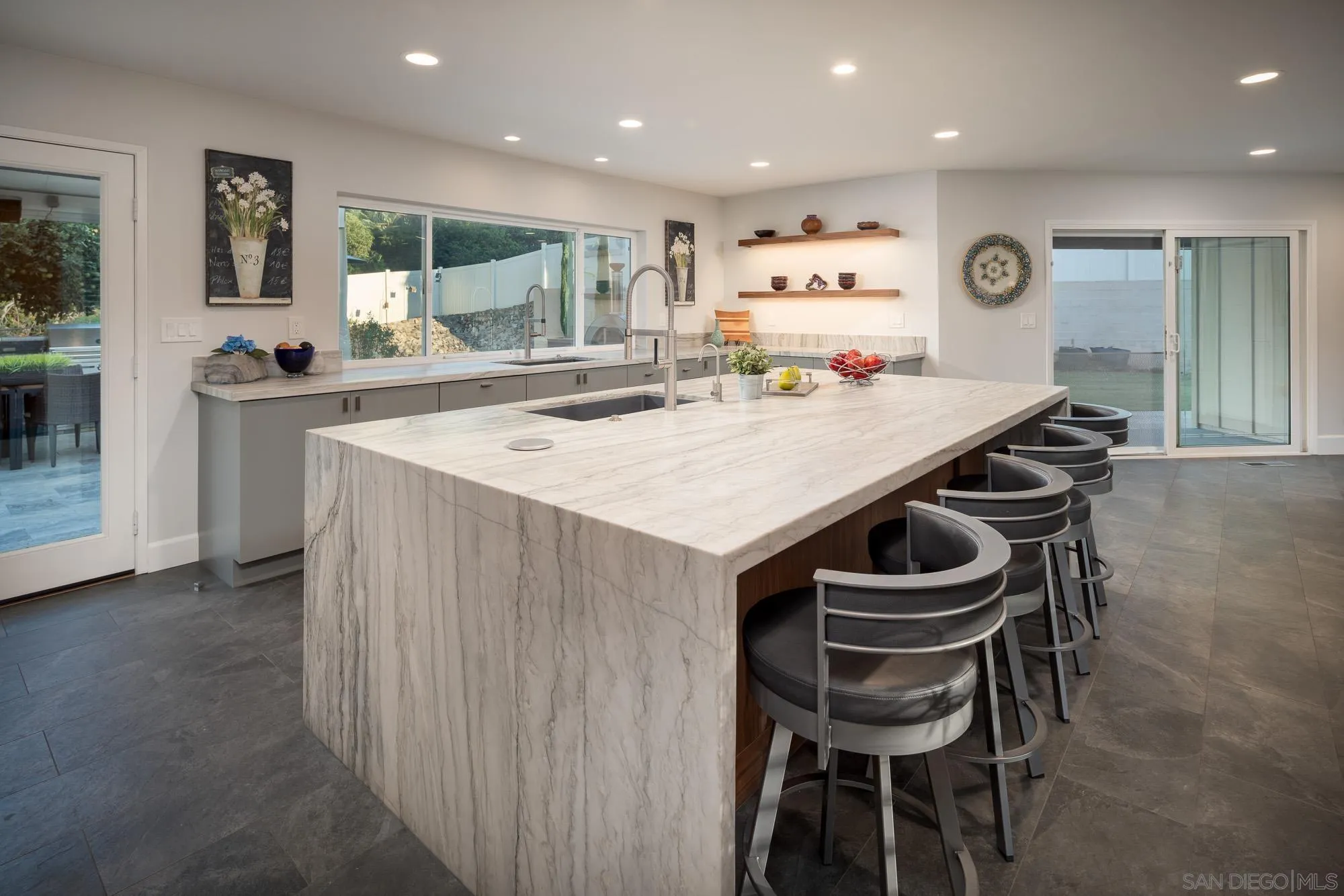 13384 Fallen Leaf Road Poway, CA 92064 - Photo 9 of 27 a large kitchen with a table and chairs