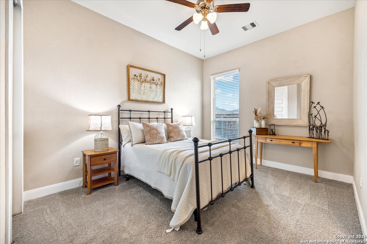 419 Heidelberg Road New Braunfels, TX 78132 - Photo 12 of 62 a spacious bedroom with a bed and a chandelier