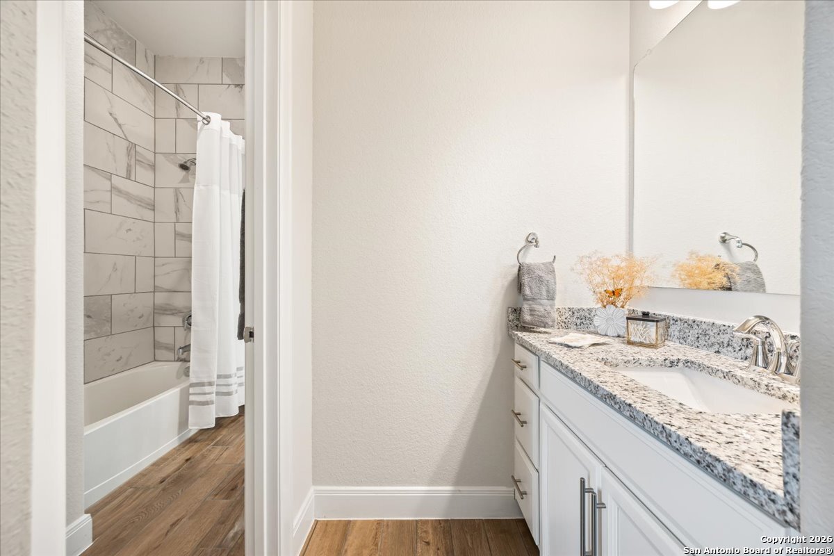 419 Heidelberg Road New Braunfels, TX 78132 - Photo 13 of 62 a bathroom with a granite countertop sink and a mirror