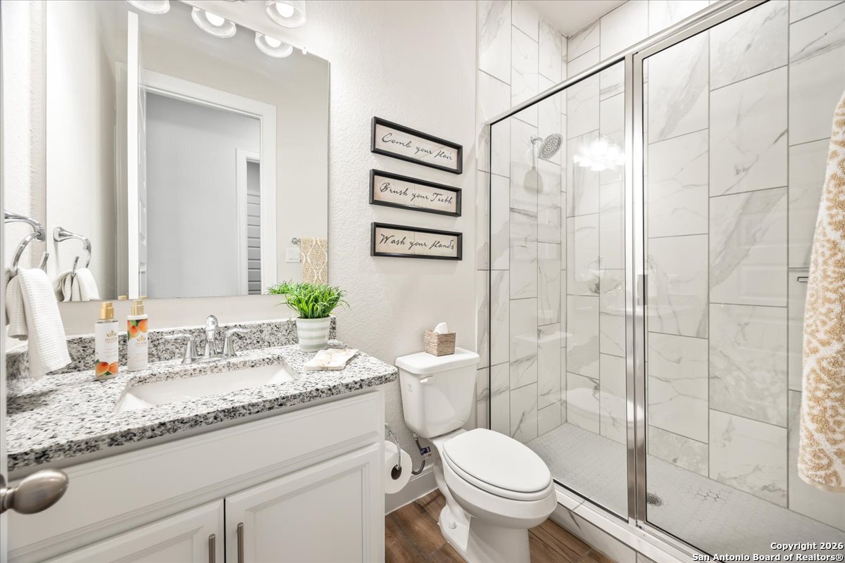 419 Heidelberg Road New Braunfels, TX 78132 - Photo 16 of 62 a bathroom with a granite countertop sink toilet and shower