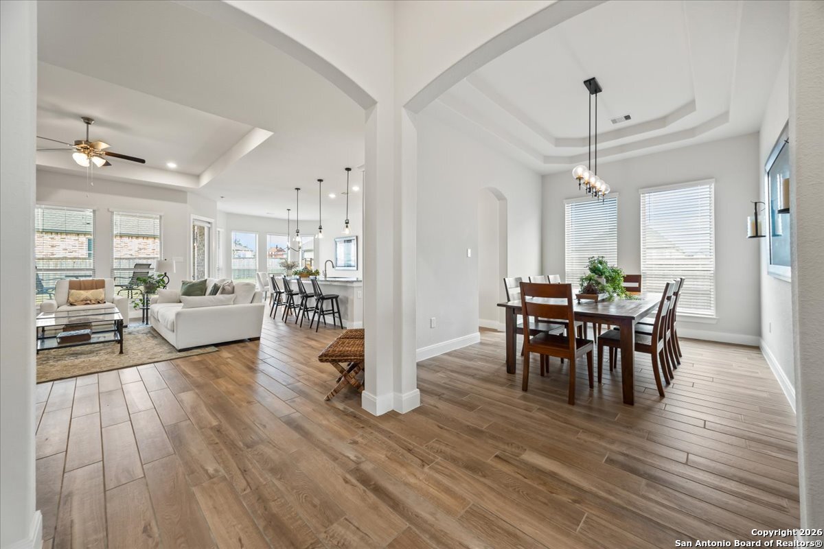 419 Heidelberg Road New Braunfels, TX 78132 - Photo 17 of 62 a view of a dining room with furniture and wooden floor