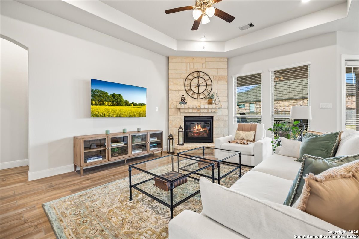 419 Heidelberg Road New Braunfels, TX 78132 - Photo 22 of 62 a living room with furniture a flat screen tv and a fireplace
