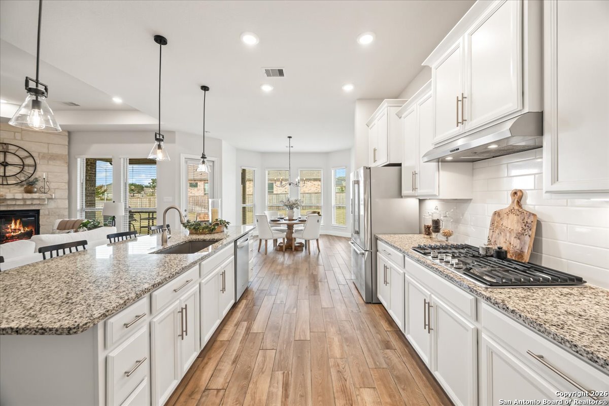 419 Heidelberg Road New Braunfels, TX 78132 - Photo 25 of 62 a kitchen with kitchen island granite countertop lots of counter top space a sink stainless steel appliances and cabinets