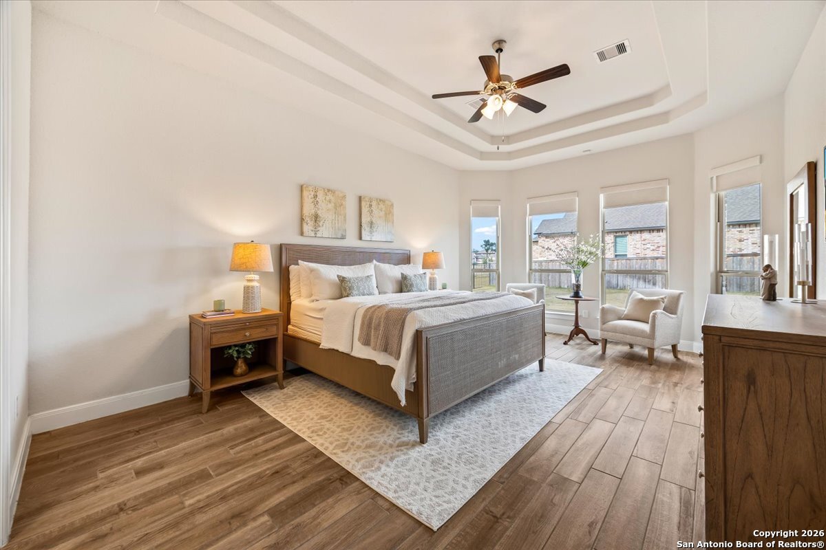 419 Heidelberg Road New Braunfels, TX 78132 - Photo 29 of 62 a bedroom with a large bed and a chandelier