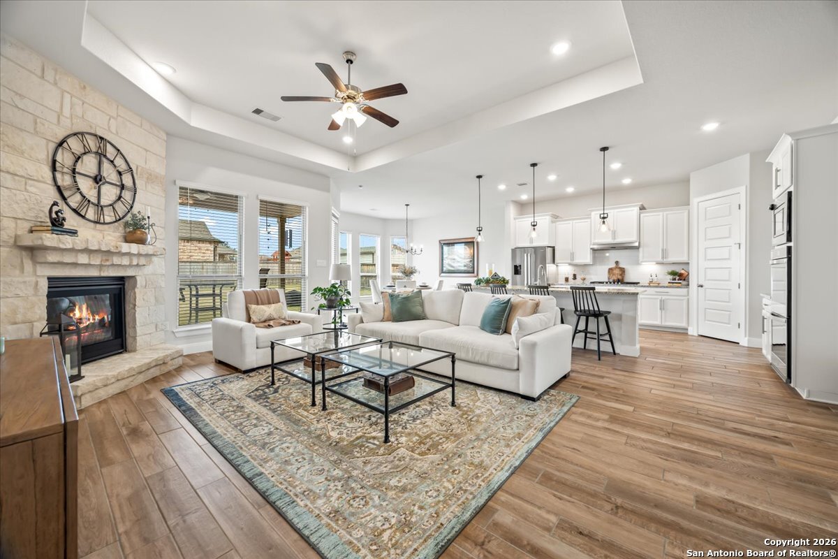 419 Heidelberg Road New Braunfels, TX 78132 - Photo 3 of 62 a living room with fireplace furniture and a wooden floor
