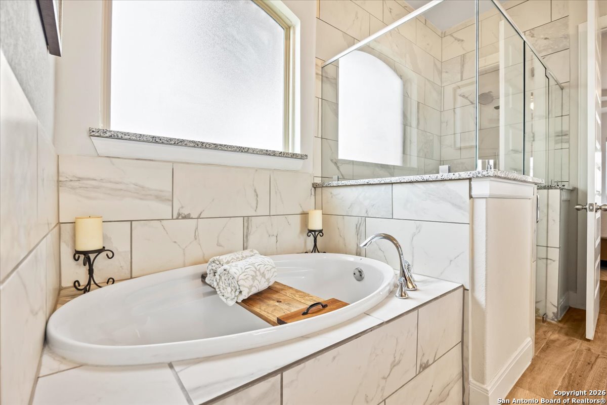 419 Heidelberg Road New Braunfels, TX 78132 - Photo 33 of 62 a bathroom with a tub and a window