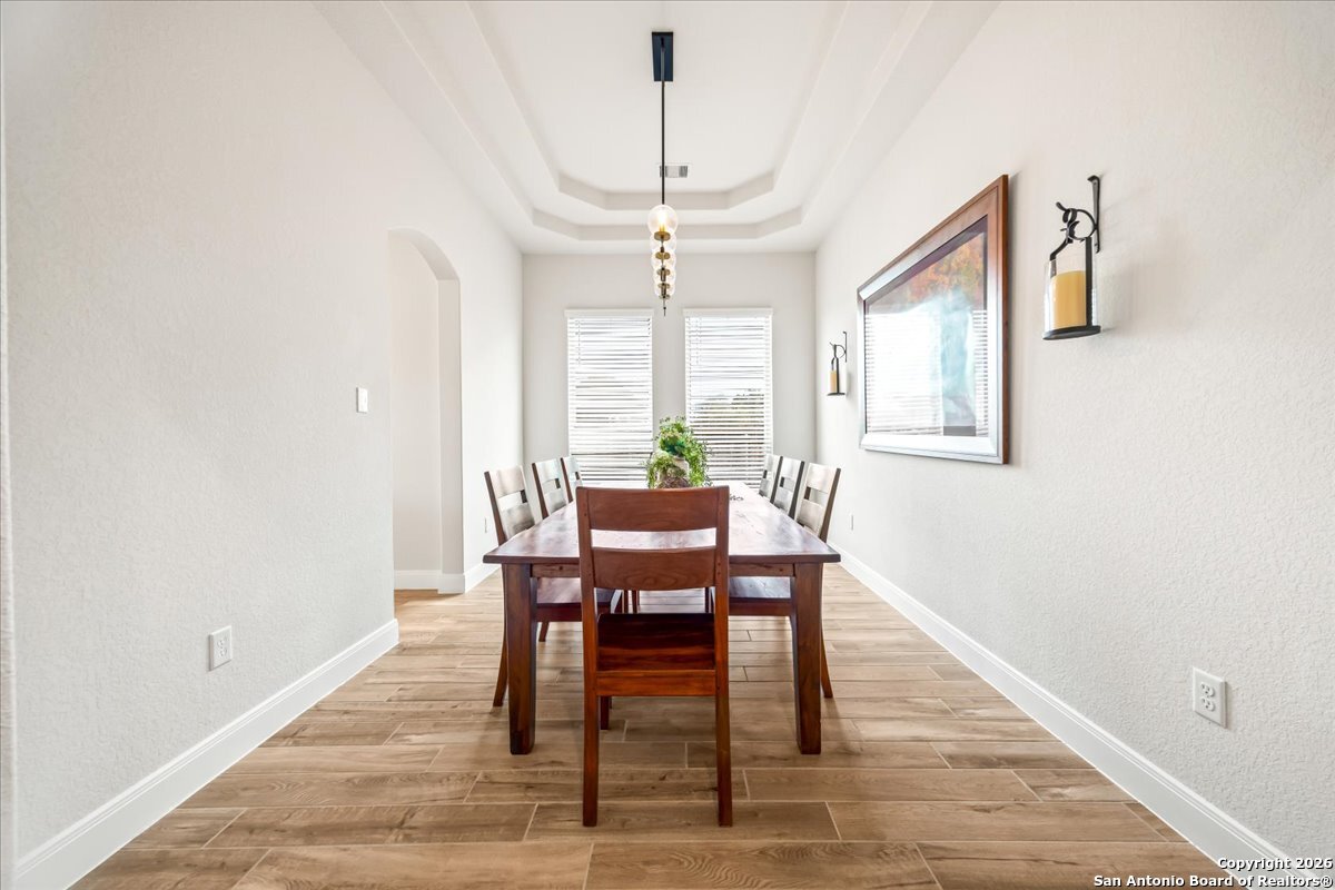 419 Heidelberg Road New Braunfels, TX 78132 - Photo 5 of 62 a dining room with furniture a chandelier and wooden floor