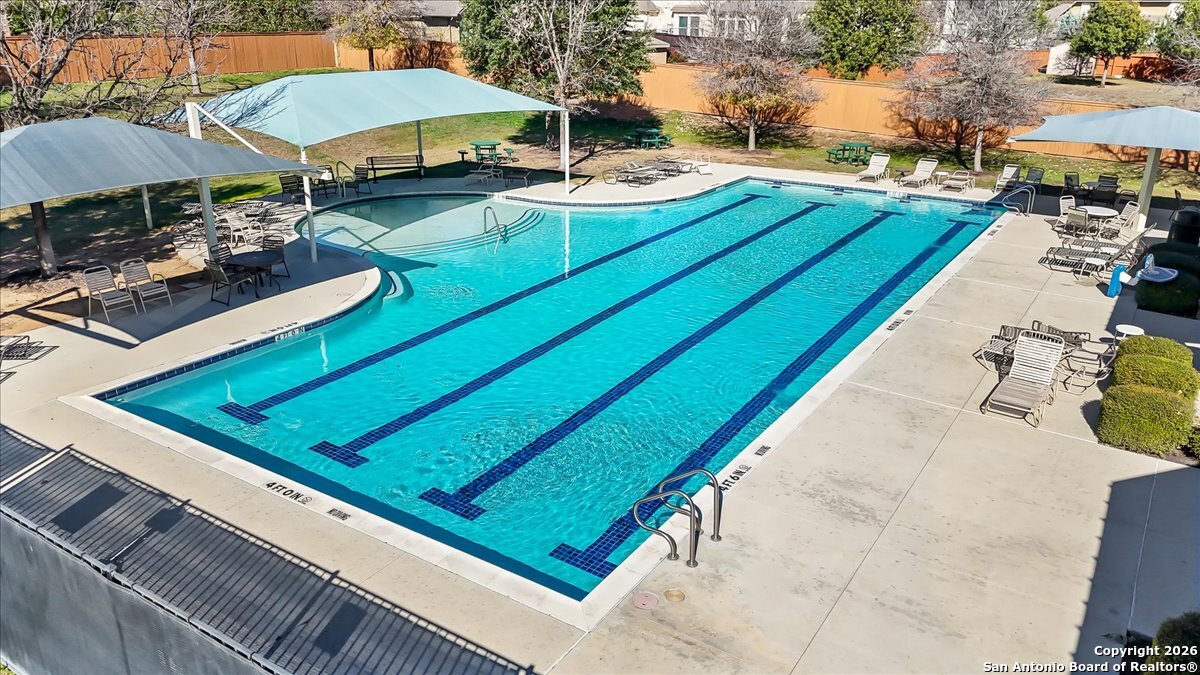 419 Heidelberg Road New Braunfels, TX 78132 - Photo 58 of 62 a view of a backyard with chairs and table under an umbrella