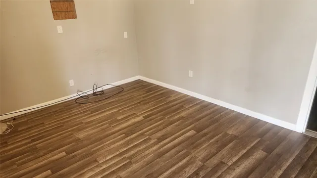 a view of a room with wooden floor