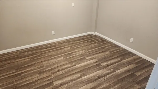 a bathroom with a granite countertop toilet sink and mirror