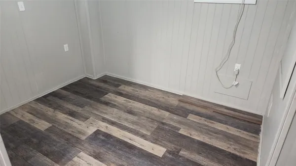 a kitchen with a table chairs and refrigerator