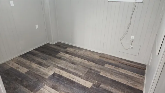 a kitchen with a table chairs and refrigerator