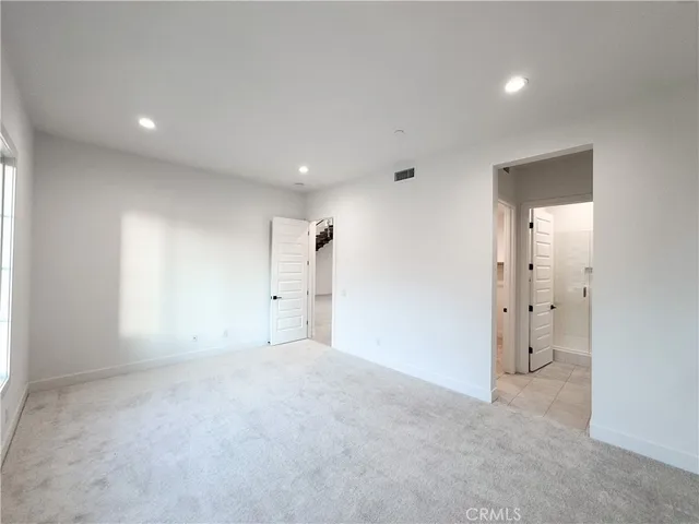 an empty room with a empty space and windows