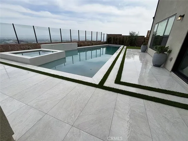 an aerial view of residential houses with city view