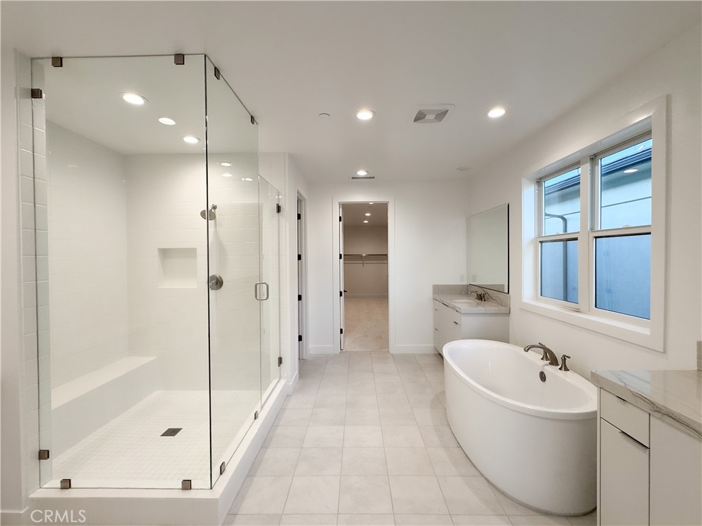 20138 Marlow Lane Porter Ranch, CA 91326 - Photo 21 of 32 a bathroom with a bathtub and a shower