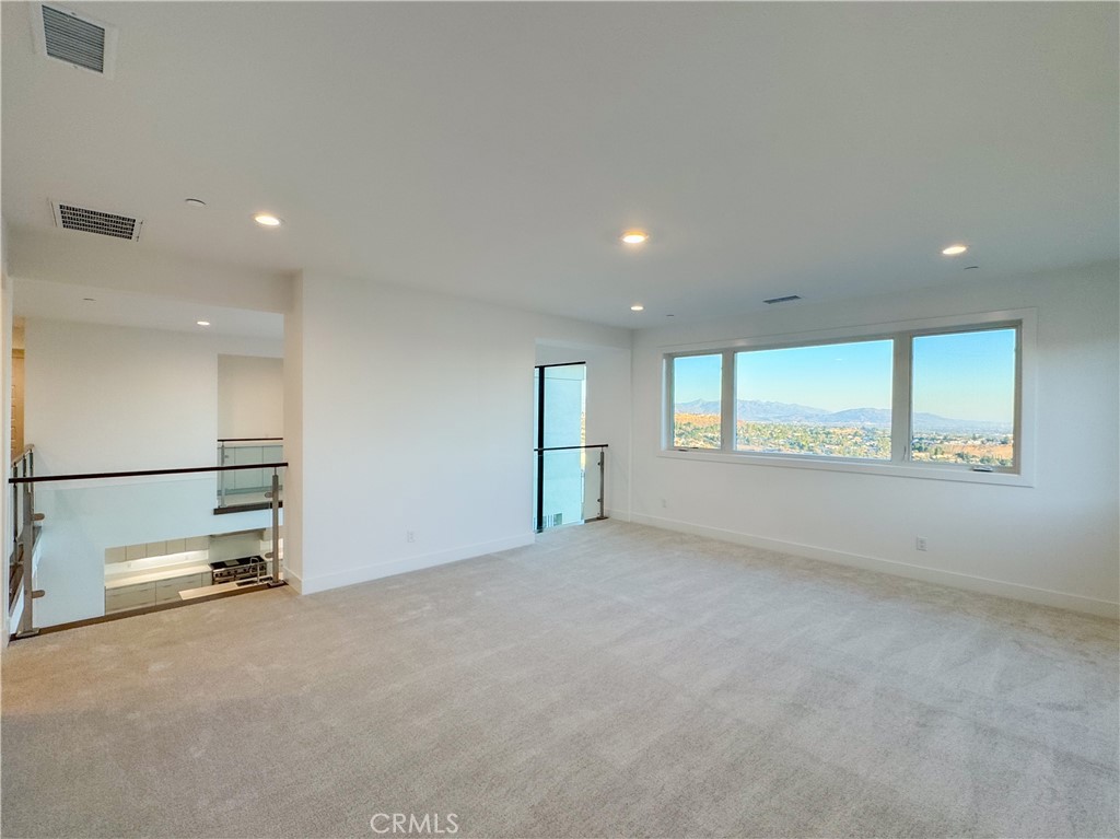 20138 Marlow Lane Porter Ranch, CA 91326 - Photo 25 of 32 an empty room with a empty space and windows