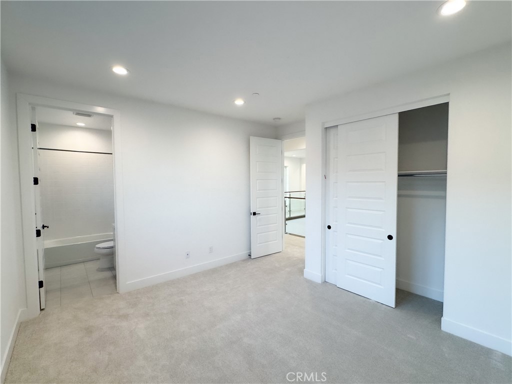 20138 Marlow Lane Porter Ranch, CA 91326 - Photo 26 of 32 an empty room with closet and wooden shelves