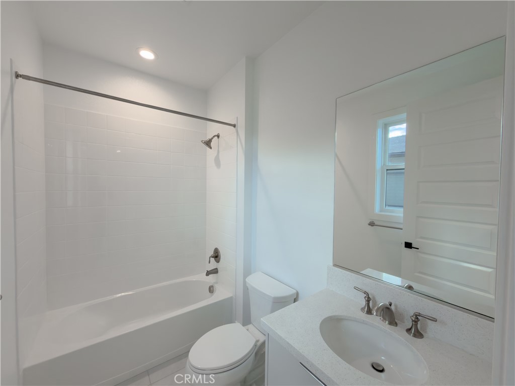 20138 Marlow Lane Porter Ranch, CA 91326 - Photo 30 of 36 a bathroom with a bathtub shower sink vanity mirror and toilet