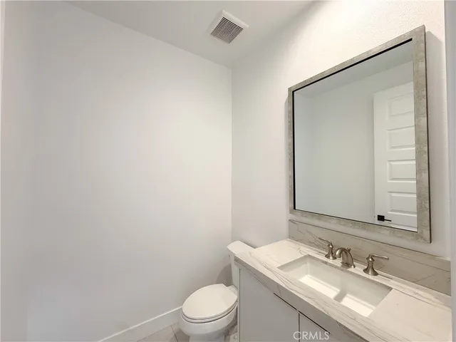a kitchen with granite countertop a sink stainless steel appliances and cabinets