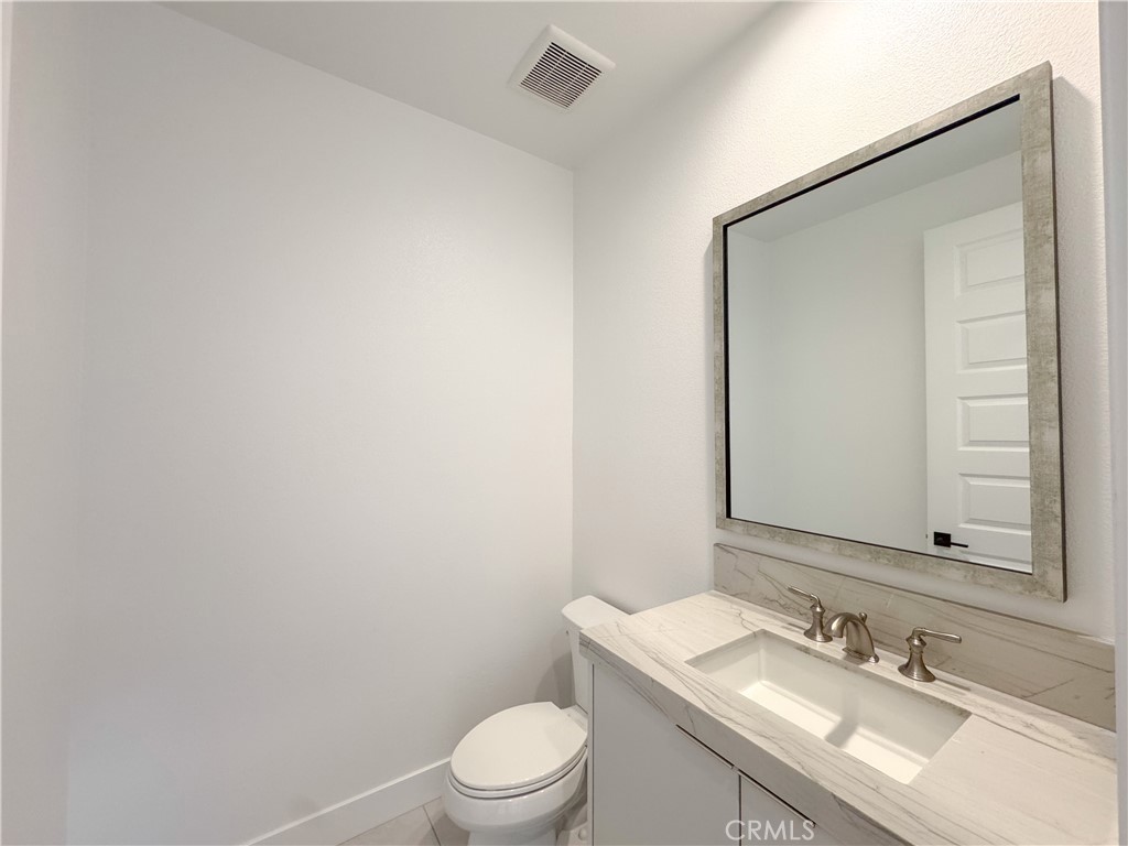 20138 Marlow Lane Porter Ranch, CA 91326 - Photo 7 of 32 a bathroom with a sink toilet and mirror