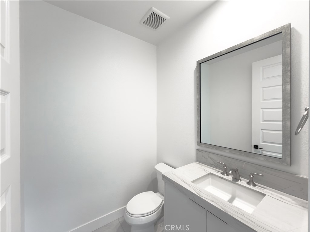 20138 Marlow Lane Porter Ranch, CA 91326 - Photo 8 of 36 a bathroom with a granite countertop sink a toilet and mirror