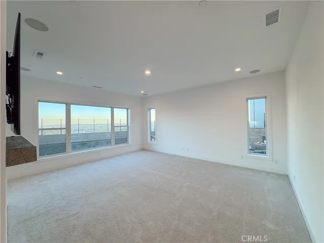 an empty room with a ceiling fan and window