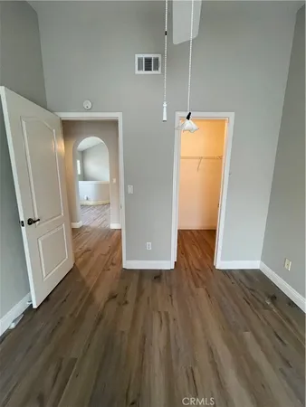 a view of a room with wooden floor and a sink