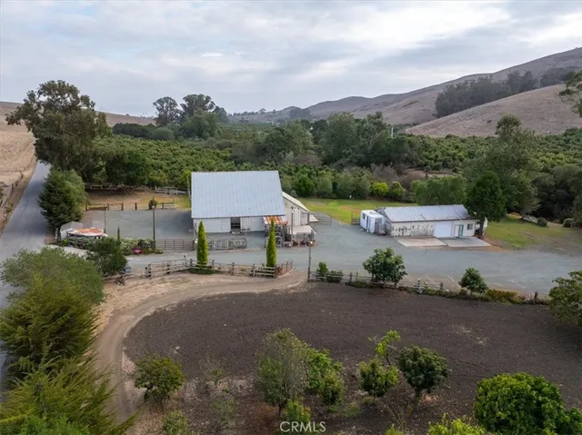 an aerial view of a house with garden space and street view