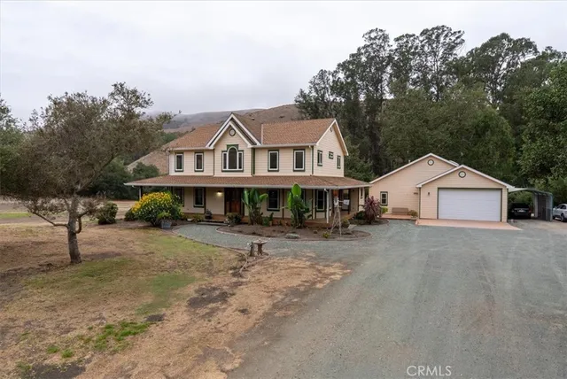 an aerial view of a house with a yard and balcony