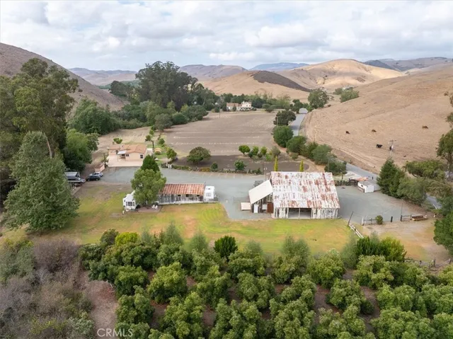 a view of a dry yard with mountains in the background