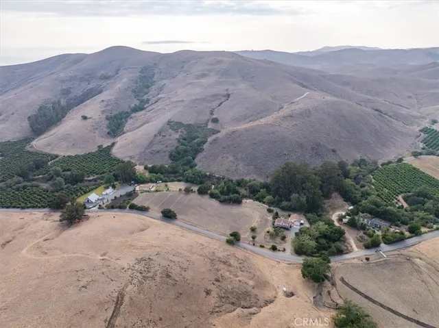 a spacious bedroom with a large bed a chandelier and closet