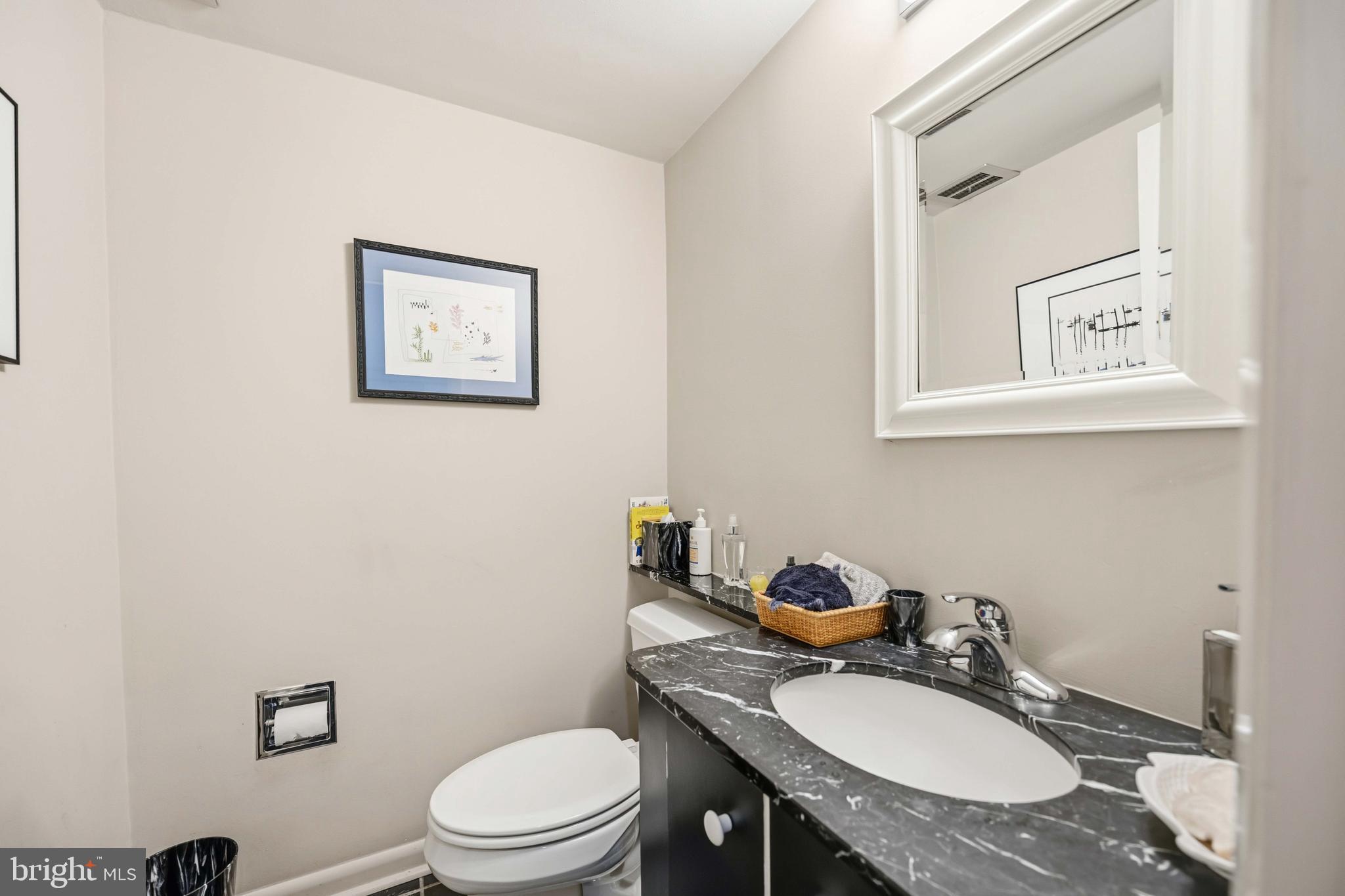330 Bent Road Wyncote, PA 19095 - Photo 17 of 47 a bathroom with a granite countertop toilet sink and mirror