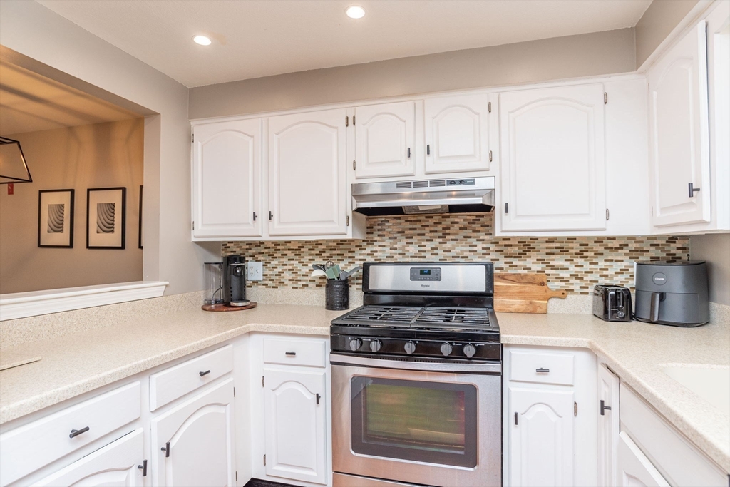 4 Colonial Drive, Unit 4 Norton, MA 02766 - Photo 17 of 34 a kitchen with granite countertop white cabinets and white appliances
