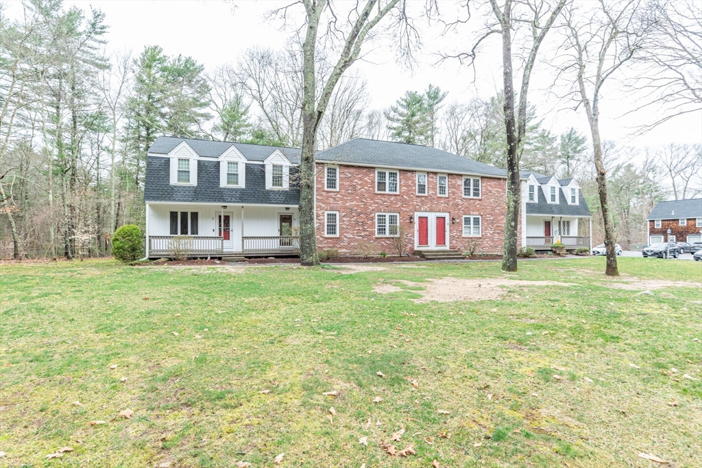4 Colonial Drive, Unit 4 Norton, MA 02766 - Photo 2 of 34 a front view of a residential apartment building with a yard
