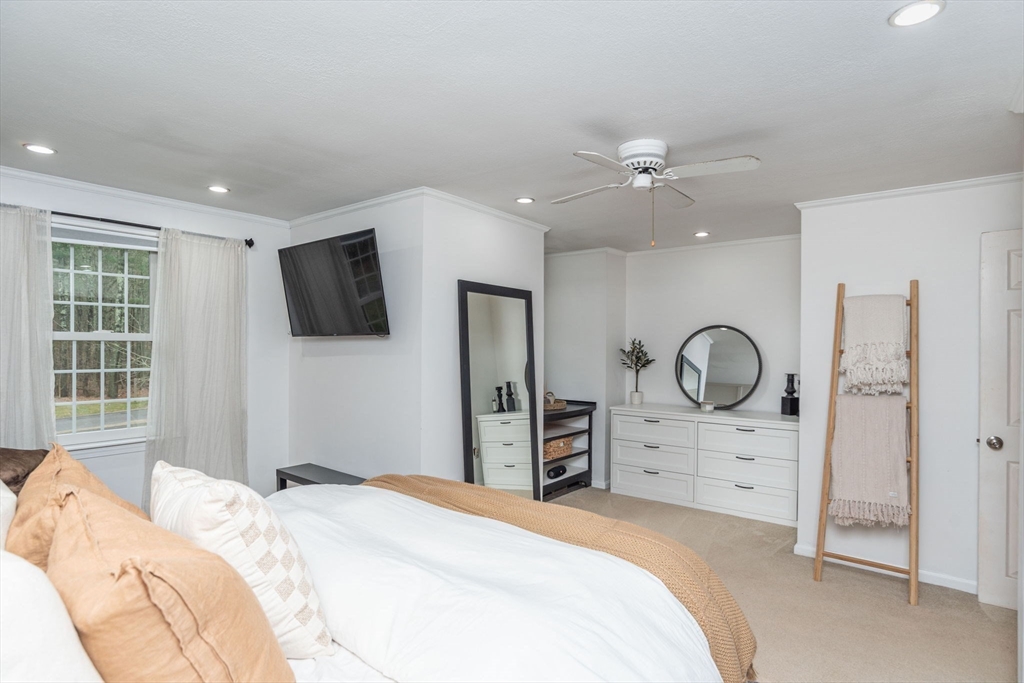 4 Colonial Drive, Unit 4 Norton, MA 02766 - Photo 23 of 34 a bedroom with a bed dresser and flat screen tv