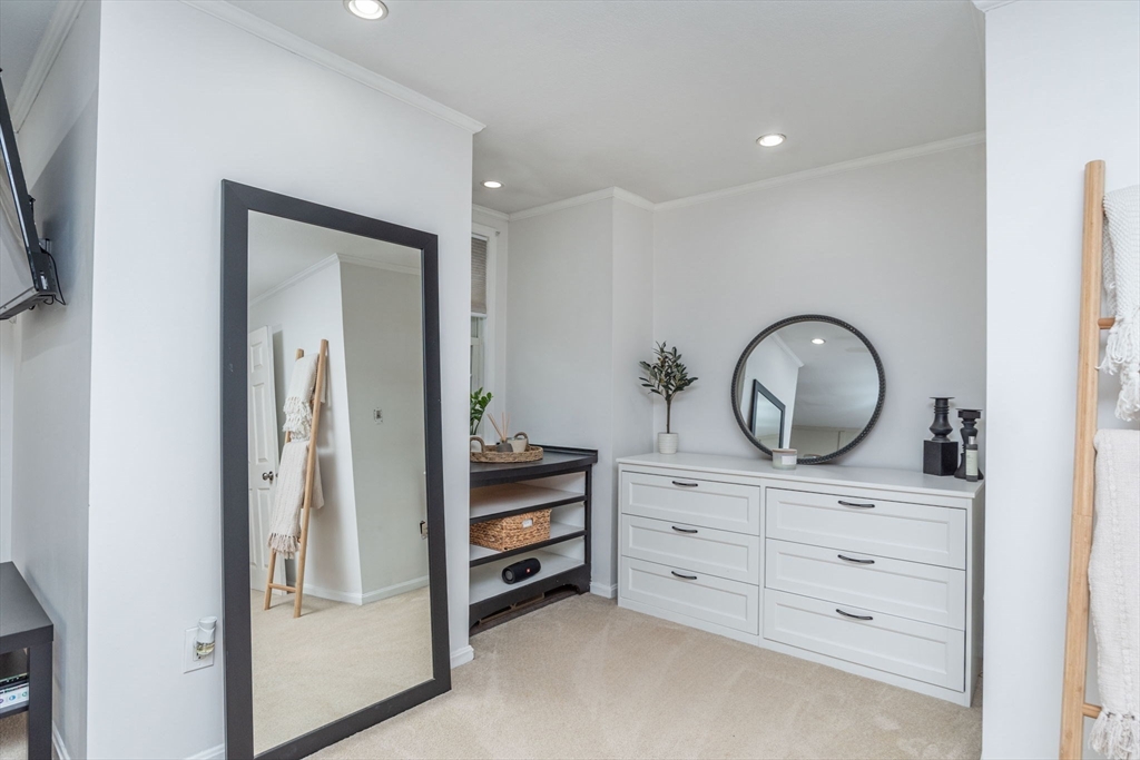 4 Colonial Drive, Unit 4 Norton, MA 02766 - Photo 25 of 34 a room with cabinets and a mirror