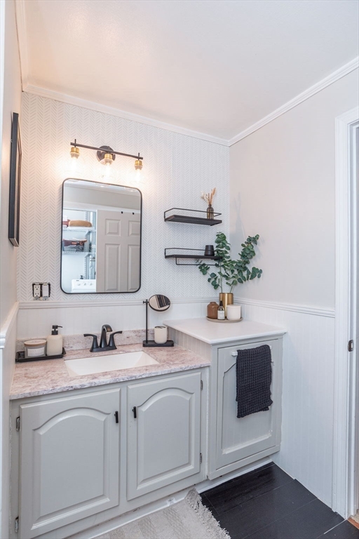4 Colonial Drive, Unit 4 Norton, MA 02766 - Photo 32 of 34 a bathroom with a sink and a mirror
