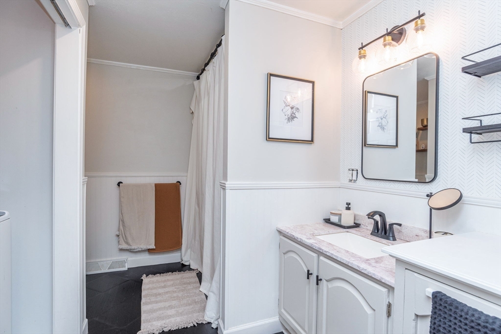 4 Colonial Drive, Unit 4 Norton, MA 02766 - Photo 33 of 34 a bathroom with a sink and a mirror