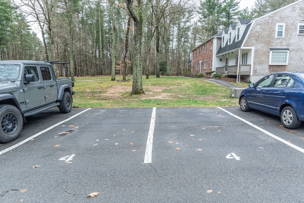 4 Colonial Drive, Unit 4 Norton, MA 02766 - Photo 4 of 34 a view of a car parked in front of a house