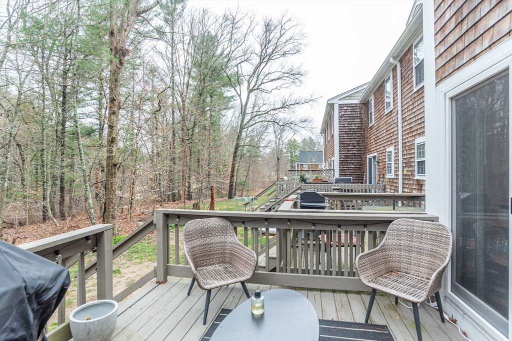 4 Colonial Drive, Unit 4 Norton, MA 02766 - Photo 7 of 34 a view of a chairs on the deck