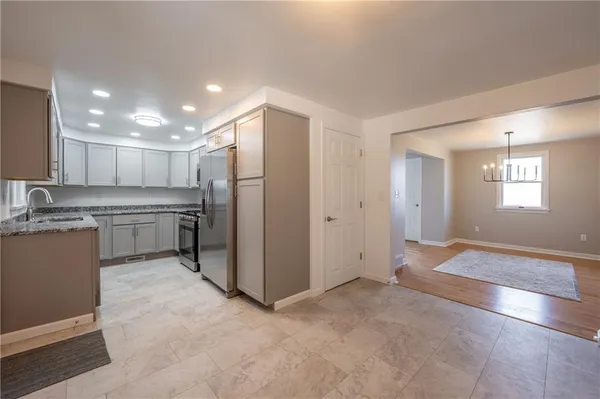 a view of a kitchen with a sink and microwave
