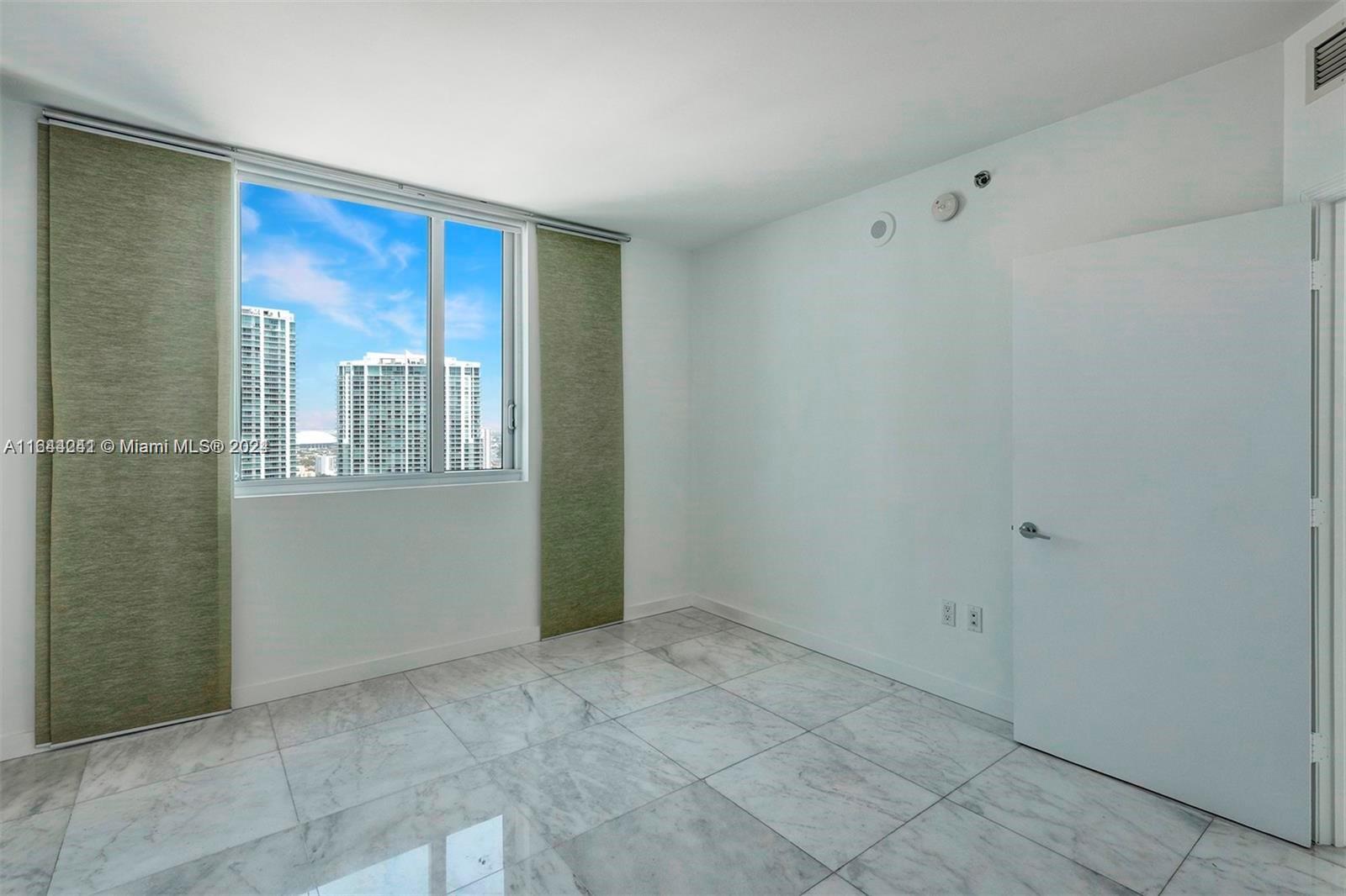 55 Southeast 6th Street, Unit 3401 Miami, FL 33131 - Photo 16 of 19 a view of an empty room with a window