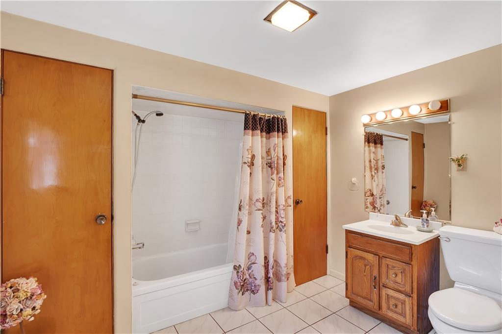 5986 Italy Road Export, PA 15632 - Photo 17 of 21 Main Floor Full Bathroom with Tile Floor, Tile Tub/Shower Surround, 2 Spacious Linen Closets and Grab Bar Next to Toilet.
