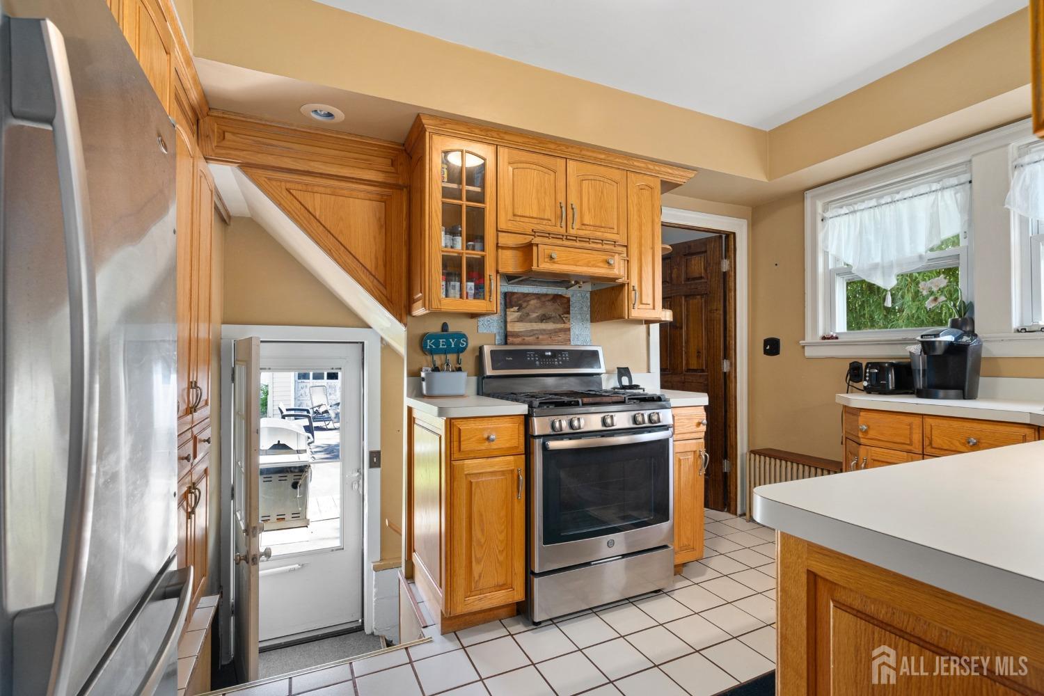23 Reed Street Edison, NJ 08817 - Photo 12 of 27 a kitchen with stainless steel appliances granite countertop a refrigerator and a stove