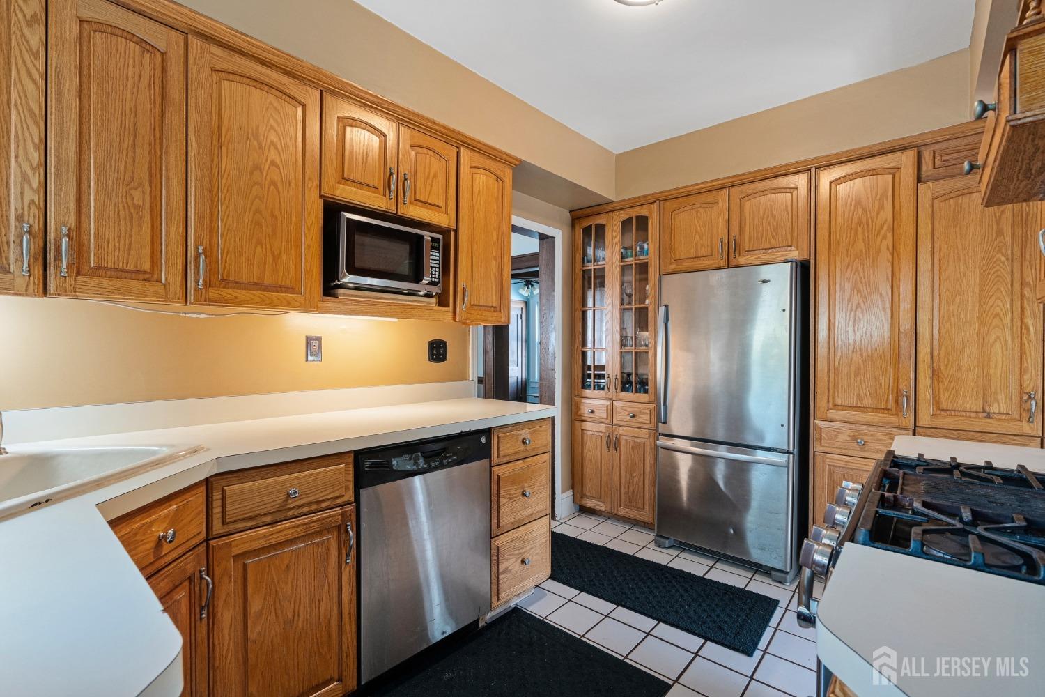 23 Reed Street Edison, NJ 08817 - Photo 13 of 27 a kitchen with stainless steel appliances granite countertop a refrigerator and a stove top oven