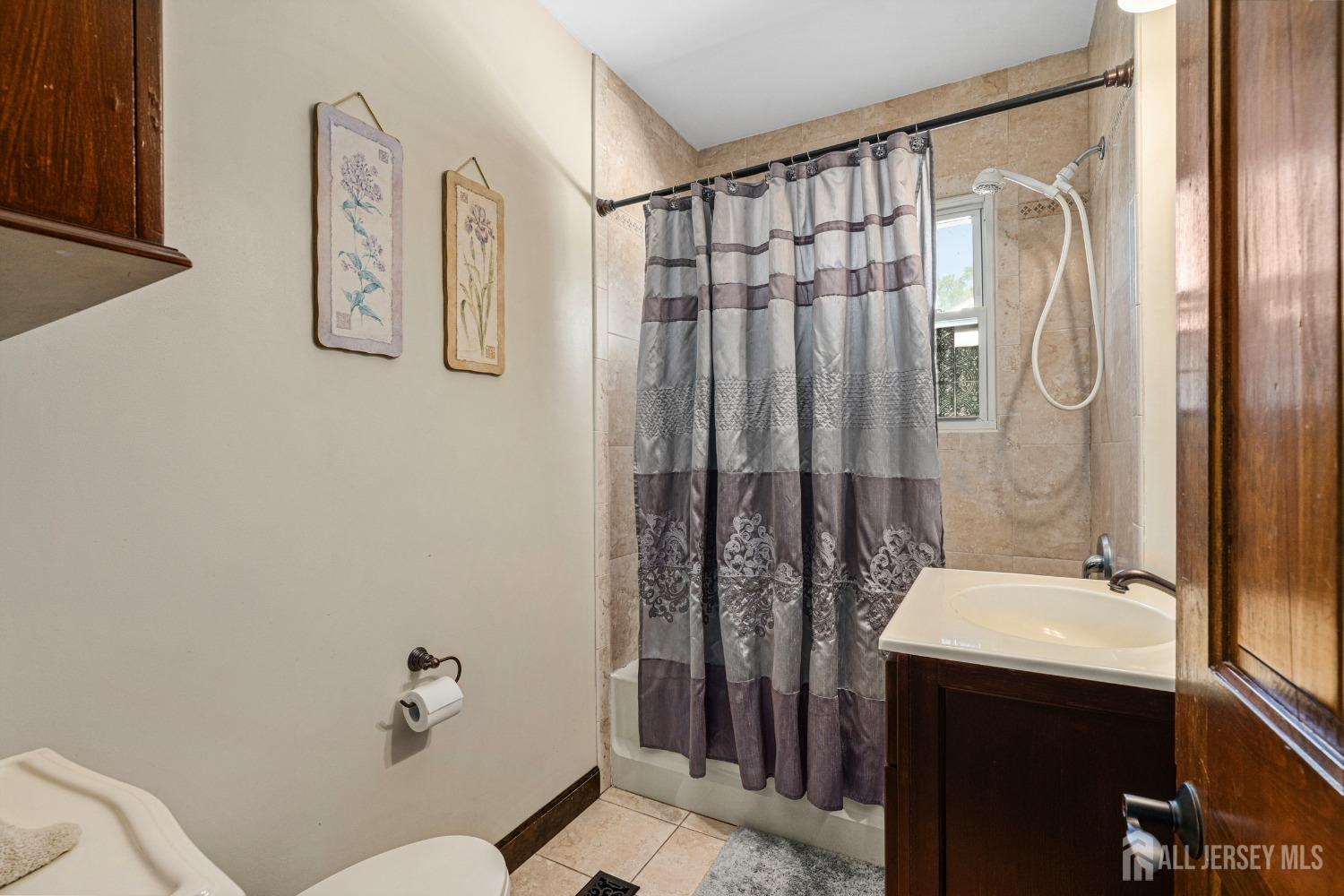 23 Reed Street Edison, NJ 08817 - Photo 22 of 27 a bathroom with a sink and mirror with toilet