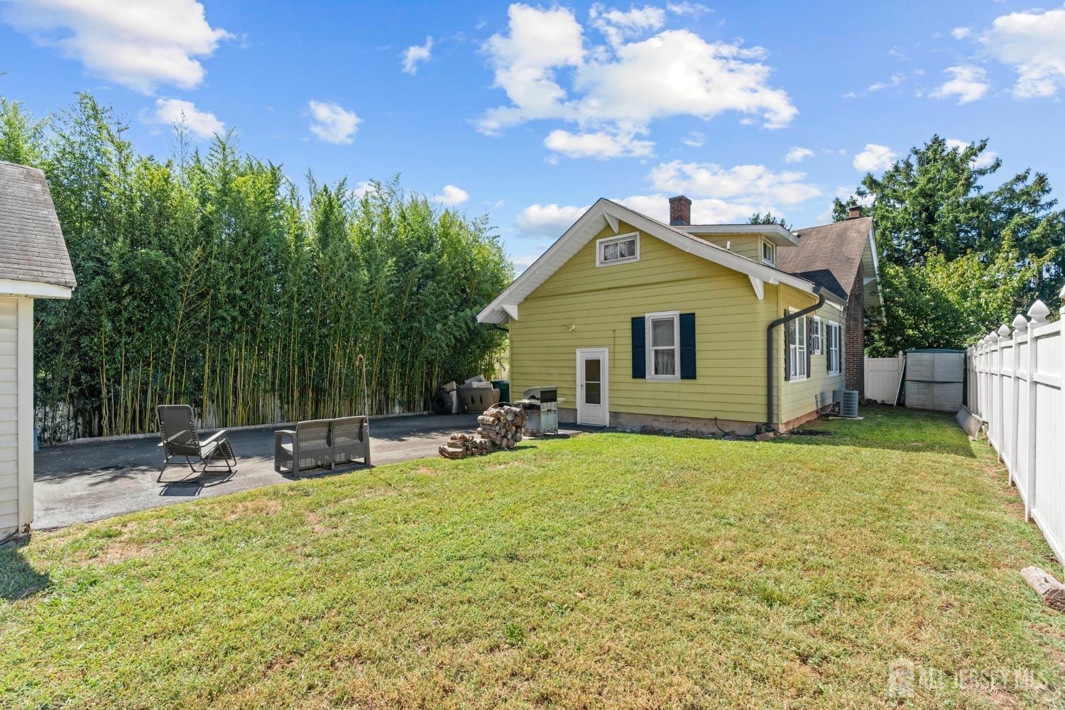 23 Reed Street Edison, NJ 08817 - Photo 24 of 27 a backyard of a house with table and chairs