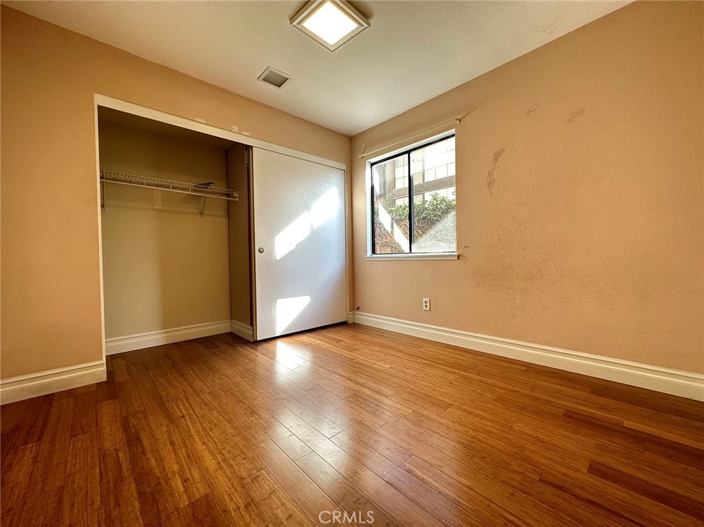 11052 Hastings Court Rancho Cucamonga, CA 91730 - Photo 8 of 14 an empty room with wooden floor and windows