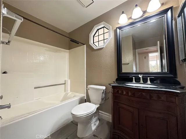 a bathroom with a toilet a sink and a mirror
